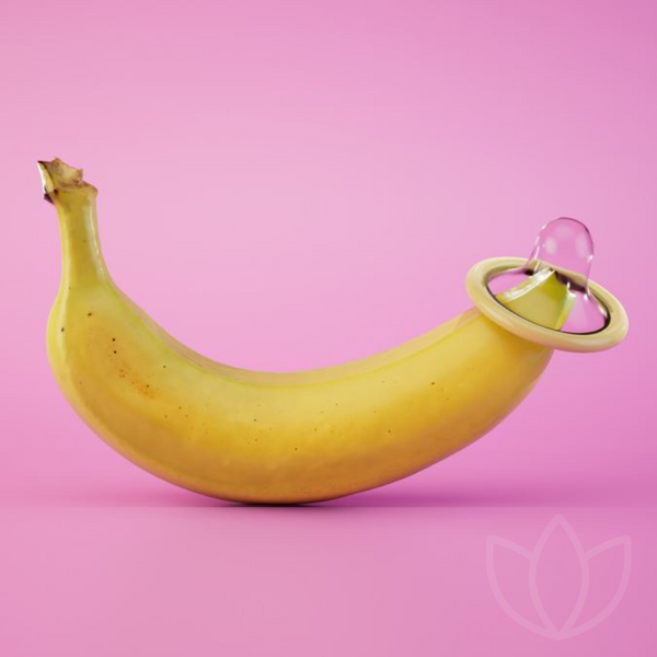 Banana with condom on pink background | Bodyjoys