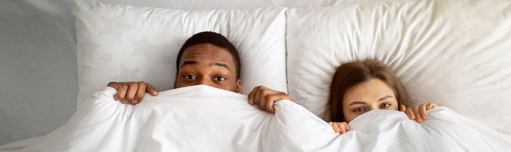 Better Sex New Arrivals | Couple Looking Out From Under Duvet | Bodyjoys